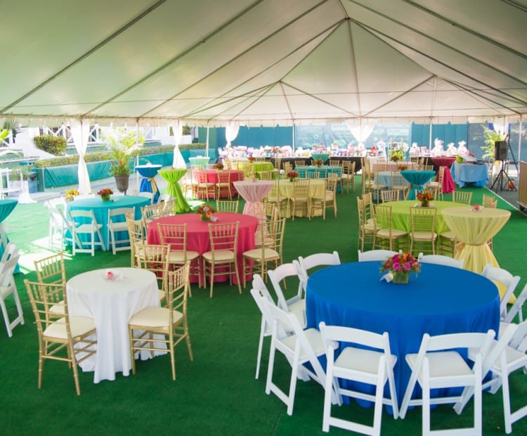 tables with colorful tablecloths under a tent